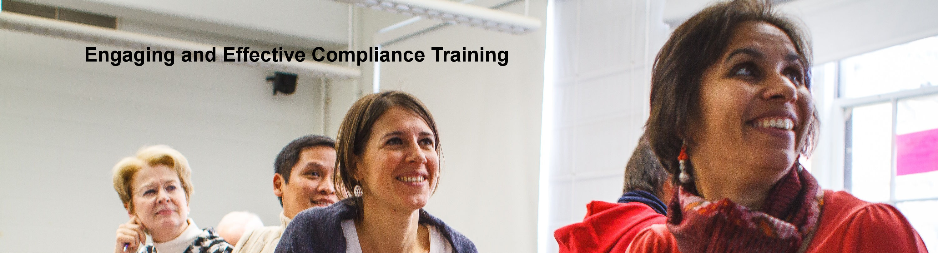 Slide 4: Engaging and Effective Compliance Training - Four smiling training participants
